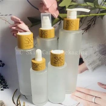 Atacado de eco-friendly de bambu superior fosco claro fosco vidro frasco de spray frascos de loção com bomba para cuidados com a pele